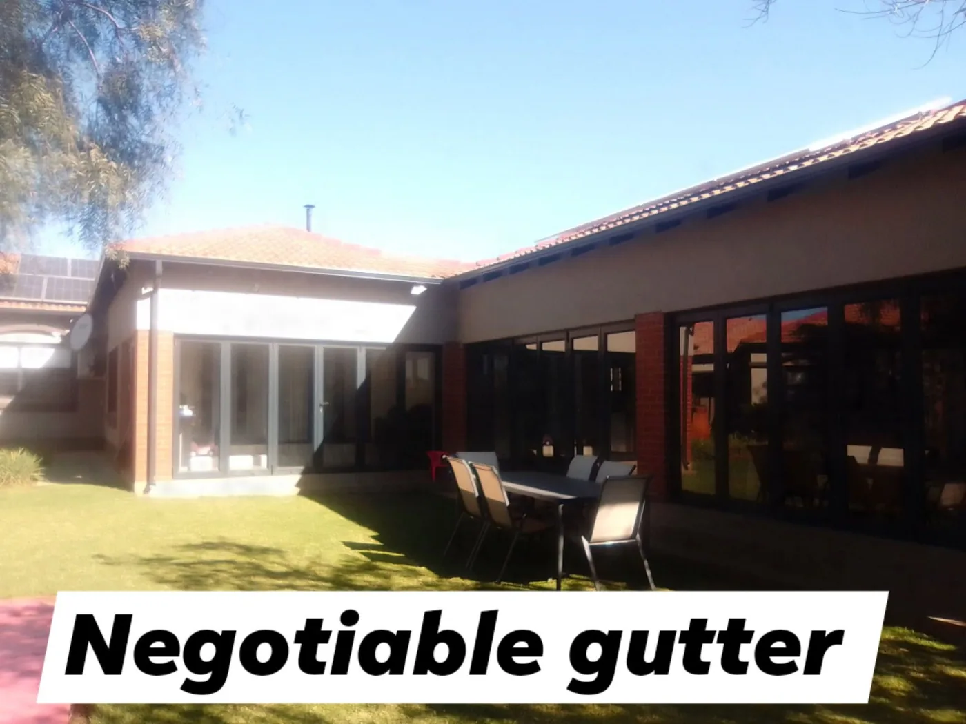 Seamless guttering above a covered patio and sliding doors