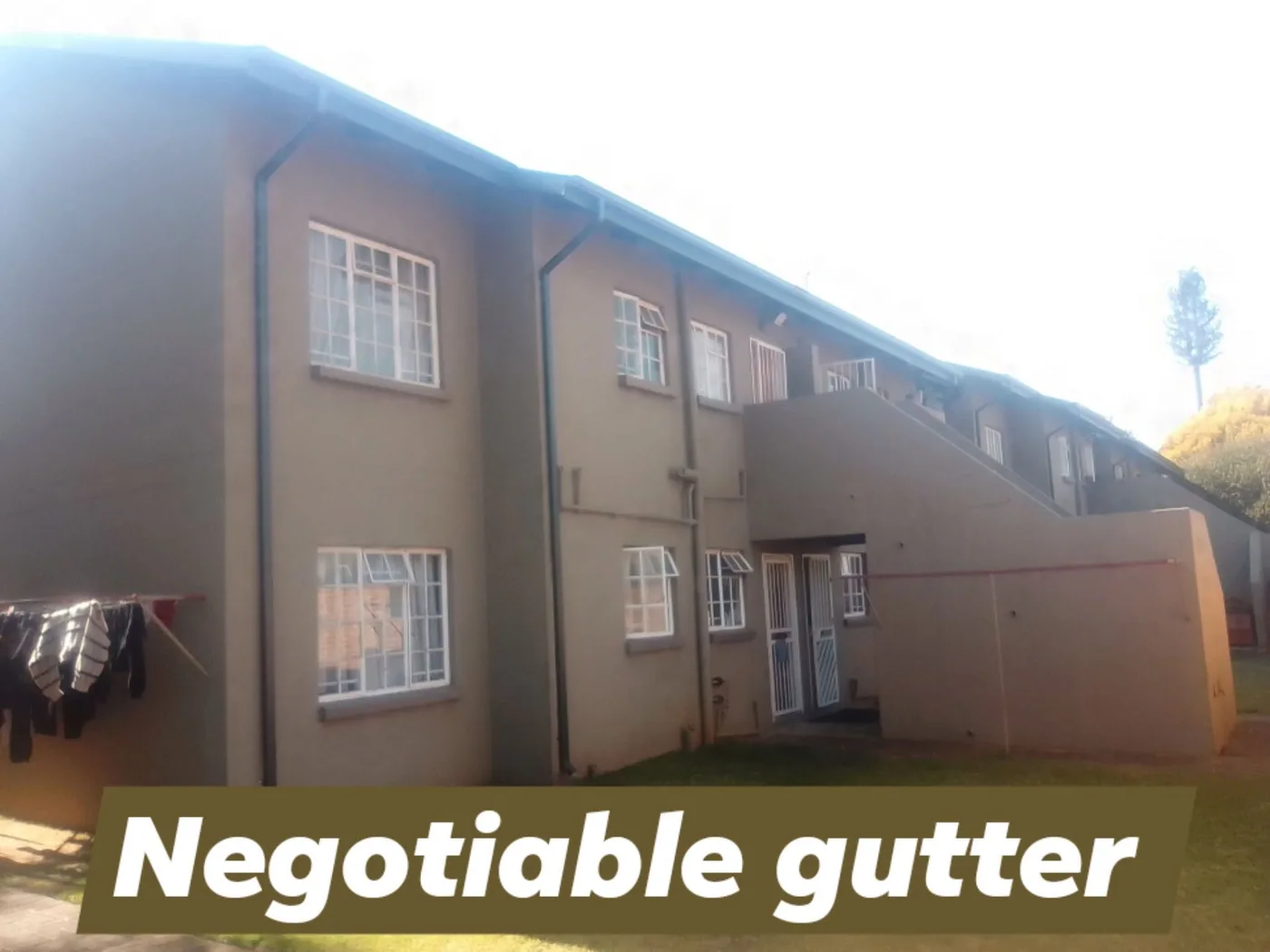 Seamless gutters fitted across a double-storey apartment block