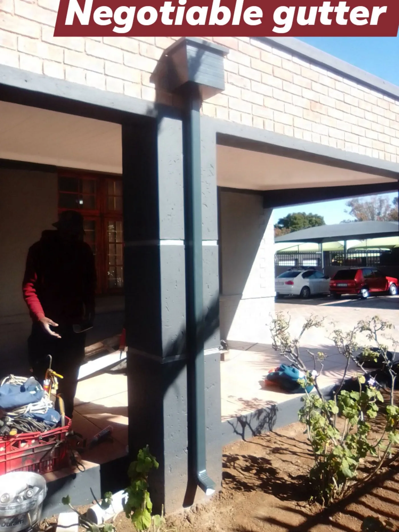 Fitting a downpipe on site under a covered walkway