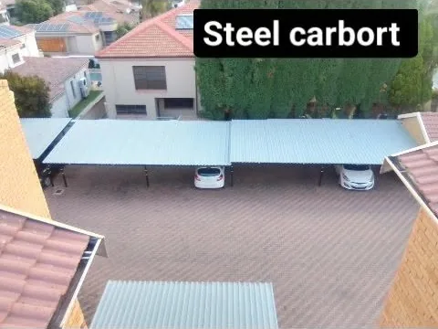 Steel carport built and roofed over a paved driveway