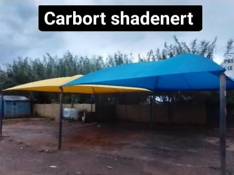 Shadenet carport covering an open parking area