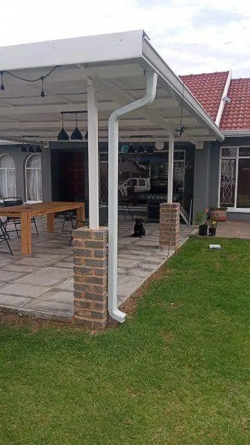 White downpipe carried down a patio column to ground level